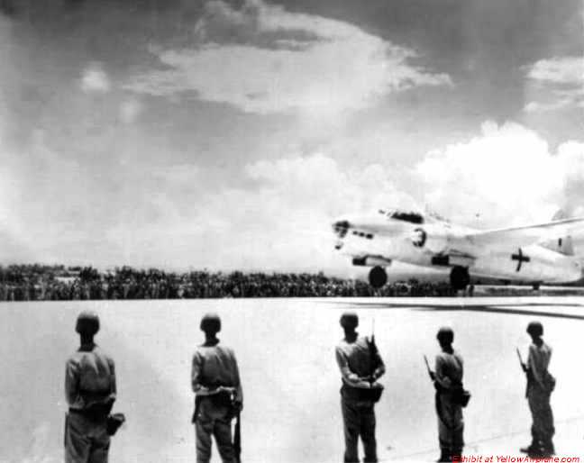 Picture of a Japanese Betty Bomber taking off with American Soldiers Standing at Parade.