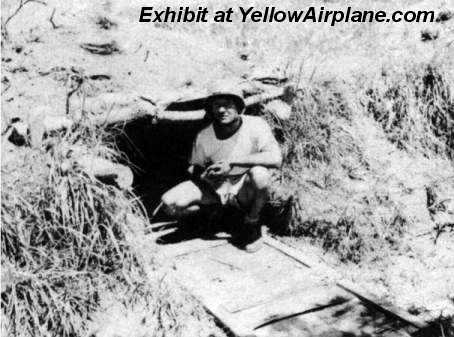 A picture of a Soldier at the entrance of a bomb shelter built by the Japanese on the island of Ie Shima in WWII