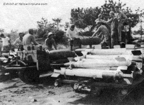 Bombs are being readied to be loaded on the fighter aircraft in WW2