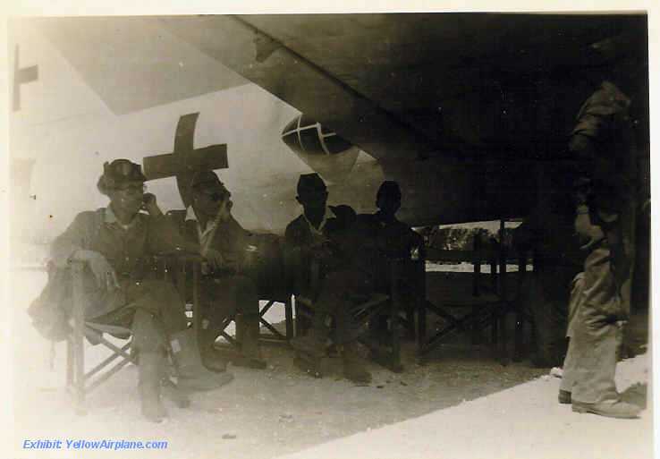 Picture of a Japanese Soldiers sitting under a wing, smoking a cigarette, while they wait on Ie Shima, Okinawa
