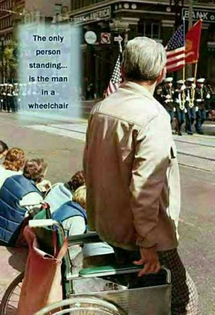 A Veteran Stands while everyone else sits.