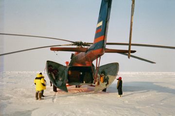Russian Mil 8 helicopter sitting on the North Pole with cargo bays open