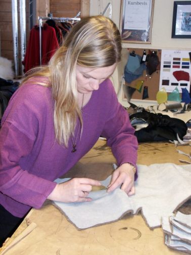 Merete At Work cutting out intricate details of her Arctic Clothing