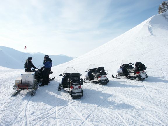 Our group mountain climbing with snowmobiles.