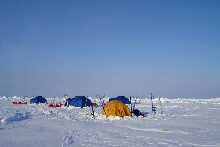 Ski members camp after extreme skiing to the North Pole