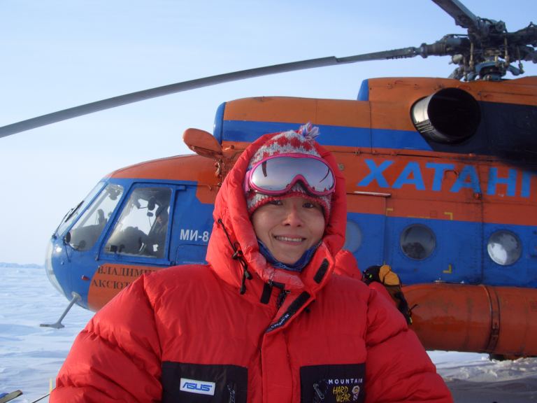 Wang Qiuyang in front of a Russian Mi-8 helicopter in a deep polar region, the North Pole