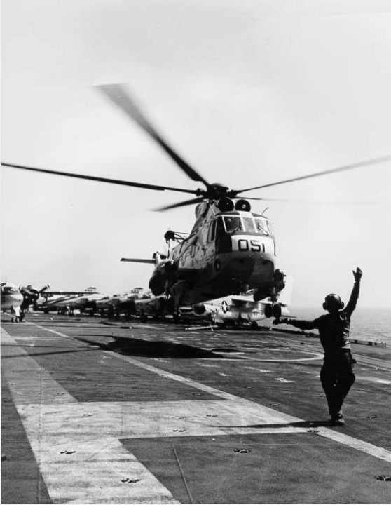 an h3 sea king lands on the deck of the aircraft carrier, uss kitty hawk